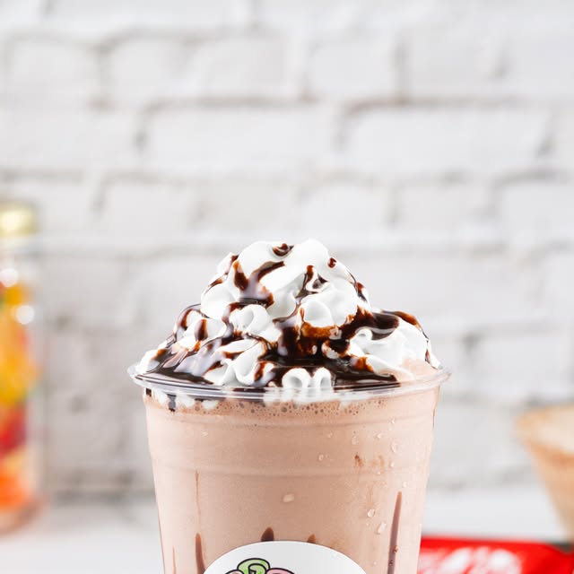 Chocolate milkshake topped with whipped cream and chocolate sauce
